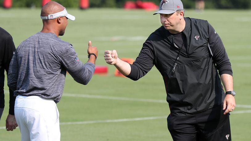 073121 Flowery Branch: Atlanta Falcons head coach Arthur Smith (right) gives general manager Terry Fontenot give each other a fist bump after speaker to Falcons fans on the third day of training camp practice on Saturday, July 31, 2021, in Flowery Branch.   “Curtis Compton / Curtis.Compton@ajc.com”