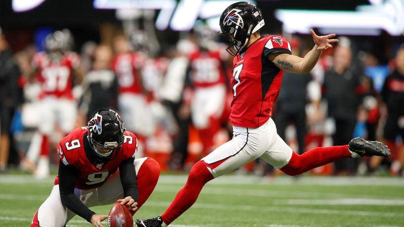 Younghoe Koo  of the Atlanta Falcons kicks a field goal as Ryan Allen  holds in the first half on an NFL game against the Carolina Panthers at Mercedes-Benz Stadium on December 8, 2019 in Atlanta, Georgia. (Photo by Todd Kirkland/Getty Images)