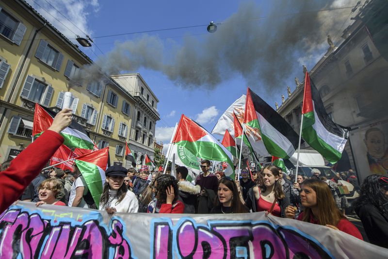 People holding Palestinians flags march on the occasion of Liberation Day in Milan, Italy, Thursday, April 25, 2024. Italy is marking its liberation from Nazi occupation and fascist rule amid a fresh media controversy over the legacy of Italian fascist complicity in the Holocaust and World War II-era crimes. (Claudio Furlan/LaPresse via AP)