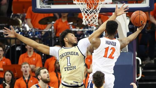 CHARLOTTESVILLE, VA - FEBRUARY 27: De'Andre Hunter #12 of the Virginia Cavaliers shoots past James Banks III #1 of the Georgia Tech Yellow Jackets in the first half during a game at John Paul Jones Arena on February 27, 2019 in Charlottesville, Virginia. (Photo by Ryan M. Kelly/Getty Images)