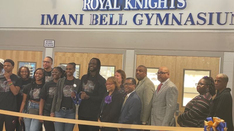 The family of Imani Bell poses for a picture Tuesday during the ribbon cutting of the newly named Imani Bell Gymnasium at Elite Scholars Academy in Jonesboro.