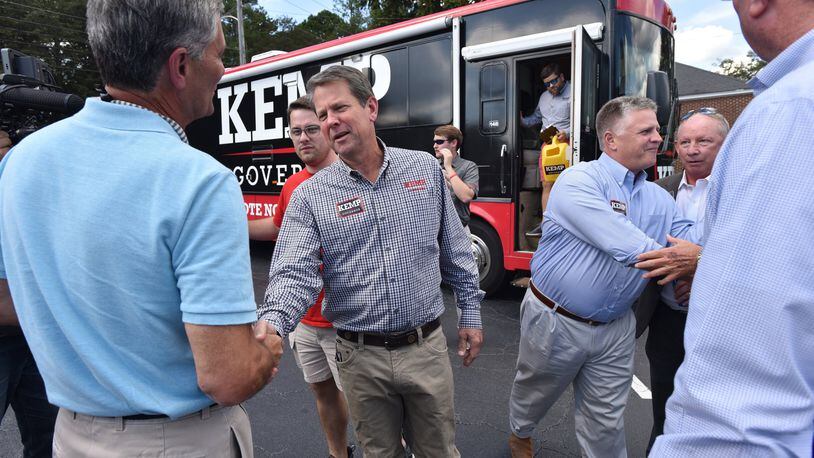 Republican gubernatorial candidate Brian Kemp greets supporters earlier this month during a bus stop tour at Sprayberry’s BBQ in Newnan. HYOSUB SHIN / HSHIN@AJC.COM