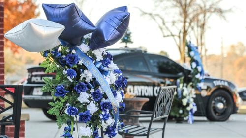 Henry Laxson’s patrol car was parked in front of Clayton County police headquarters for those wanting to drop off flowers or other gifts to honor him.