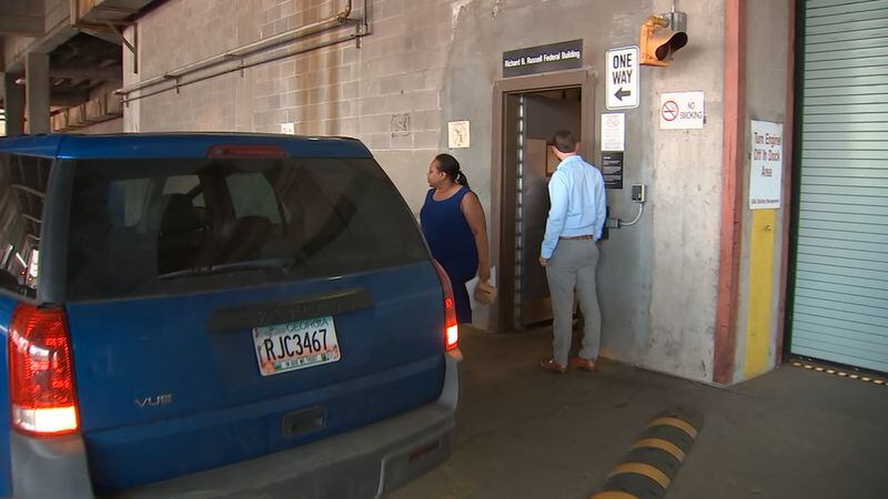 Former DeKalb County Commissioner Sharon Barnes Sutton leaves federal court in May 2019, after being released from custody on a $25,000 unsecured bond. Sutton pleaded not guilty to federal charges that she took at least one bribe from a company trying to do business with the county and two counts of extortion. CREDIT: WSB-TV