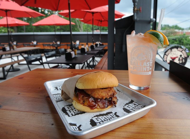Grindhouse Cowboy style burger with cheddar cheese, applewood bacon, crispy Vidalia onion ring, bbq sauce. Large Marge house blood orange margarita. (BECKY STEIN PHOT