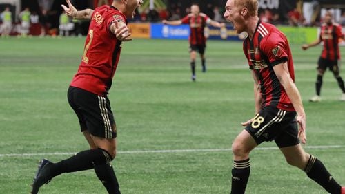 Atlanta United's Franco Escobar (left) and Jeff Larentowicz celebrate Escobar's goal, United's second in a MLS Cup victory.