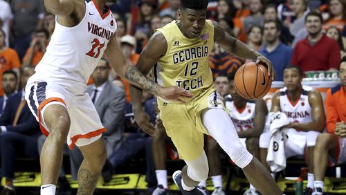 Georgia Tech's Moses Wright (12) drives past Virginia's Isaiah Wilkins (21) during the first half of an NCAA college basketball game Wednesday, Feb. 21, 2018, in Charlottesville, Va. (Zack Wajsgras/The Daily Progress via AP)
