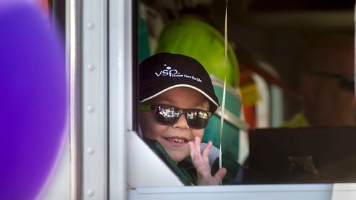 Six-year-old Ethan Dean, who was diagnosed with cystic fibrosis at two weeks old, rides in a waste truck as his wish to be a garbage man come true for a day in Sacramento, Calif., on Tuesday, July 26, 2016. Thanks to the Make-A-Wish Foundation, he got to experience what it's like to be a garbage truck driver, riding in a real garbage truck through downtown Sacramento, collecting trash and recyclables, just like he's always wanted. (Eli Hiller/Sacramento Bee via AP)