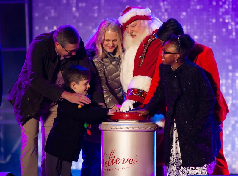 Santa Claus, with the help of Atlanta Mayor Keisha Lance Bottoms and others, helps light the tree during the Macy's 72nd Great Tree Lighting Ceremony Sunday, November 24, 2019.  STEVE SCHAEFER / SPECIAL TO THE AJC