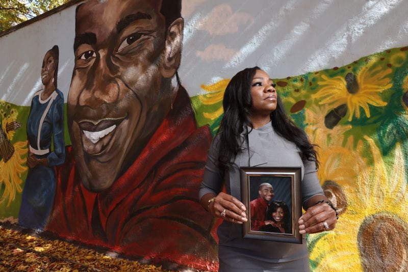 Monteria Robinson, Jamarion Robinson's mother, holds a photo of her son in front of his mural. Two members of a fugitive task force face murder and other charges in Jamarion's 2016 shooting death. (File photo)

Miguel Martinez for The Atlanta Journal-Constitution 