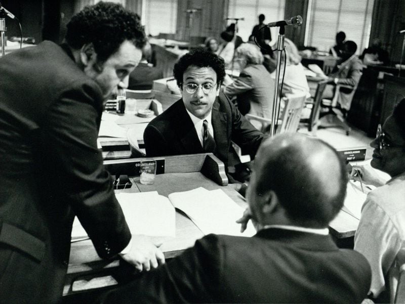 In this undated photo from the 1980s, Atlanta City Council members Jim Maddox (left), Bill Campbell (middle), and John Lewis (foreground) discuss rezoning legislation. Campbell and Lewis, along with Myrtle Davis, were elected to the council the same year, giving the council a black majority for the first time in the city’s history. (Michael Pugh / AJC Archive at GSU Library AJCP142-026z)

