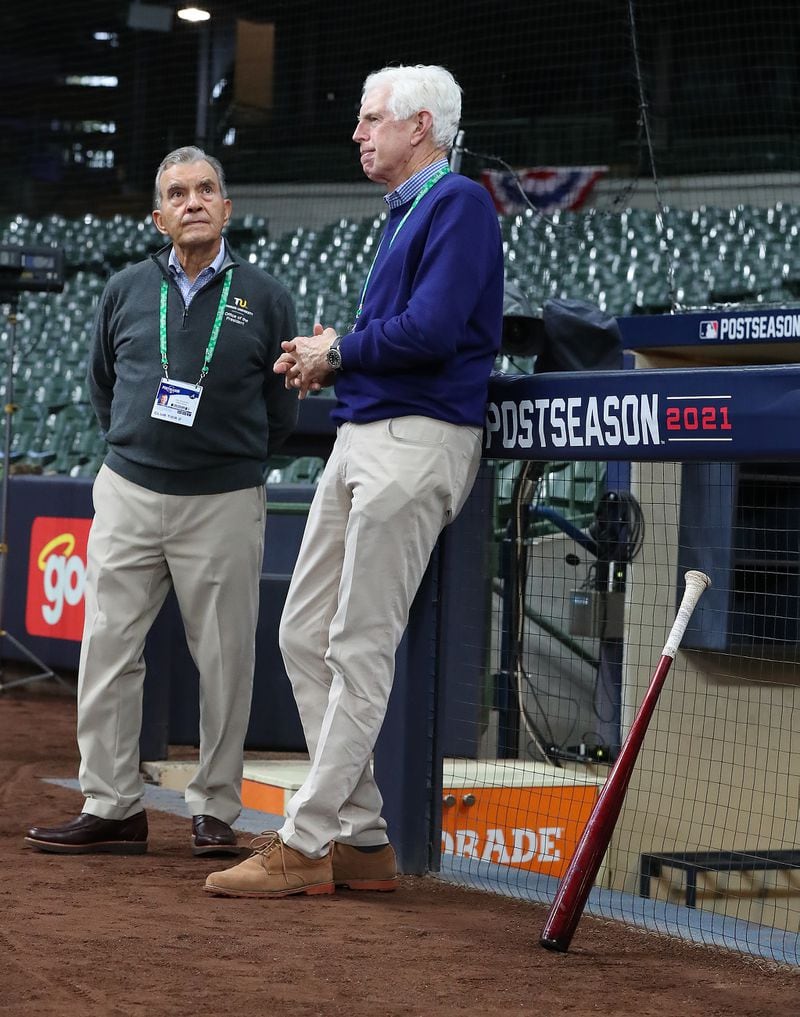 Braves Vice Chairman Emeritus John Schuerholz (left) and Chairman  Terry McGuirk (right) watch the team practice at American Family Field in Milwaukee on Oct. 7, preparing for the opening game of the National League Division Series against the Brewers. (Curtis Compton / Curtis.Compton@ajc.com)