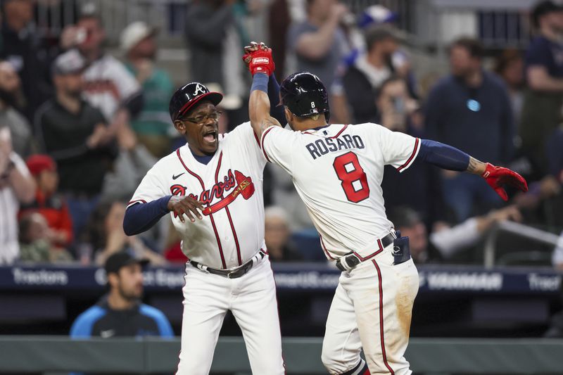 Atlanta Braves’ Eddie Rosario (8) celebrates with third base coach Ron Washington after Rosario hit a two-run home run during the fifth inning against the Miami Marlins at Truist Park, Monday, April 24, 2023, in Atlanta. The Braves won 11-0. Jason Getz / Jason.Getz@ajc.com)