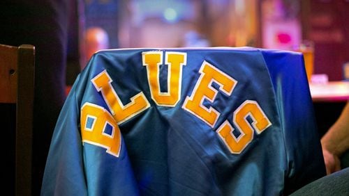 A blues music fans has a "Blues" jacket on her chair at Darwin's Burgers & Blues Saturday, April 2, 2016, in Marietta, Ga. Darwin's Burgers & Blues recently won the Keeping the Blues Alive award from The Blues Foundation in Memphis. PHOTO / JASON GETZ
