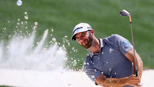 Just in case he needs it this week, Dustin Johnson works on his bunker game during a Masters practice round Tuesday. (Curtis Compton/ccompton@ajc.com)
