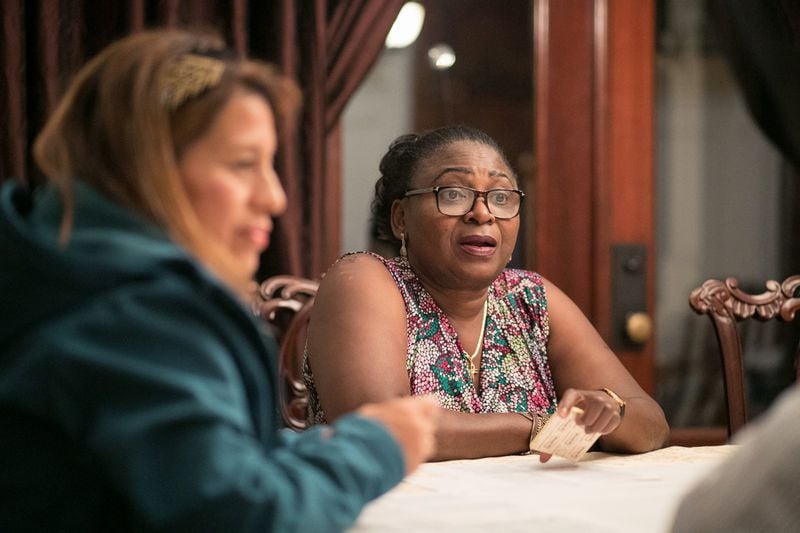Victoria Fashakin (center) of Loganville speaks to others in a small group during a Healing the Racial Divide meeting. JASON GETZ / SPECIAL