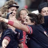 Dot Richardson (left) hugs Lisa Fernandez as Michele Smith (behind Dot) gets ready to celebrate the Americans' win of the first gold medal in the sport of softball on July 30, 1996, during the 1996 Summer Olympics in Columbus. (Renee Hannans/AJC)