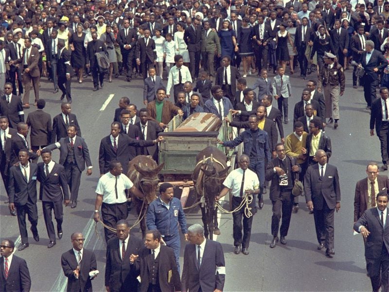 Funeral procession: two mules pull the wagon that carried the remains of Martin Luther King Jr. through the streets of Atlanta on April 9, 1968. The wagon was acquired by the King family and donated to the National Park Service, which is making it the centerpiece of an exhibit opening April 4 at the King National Historic Site in Atlanta. (AP photo)