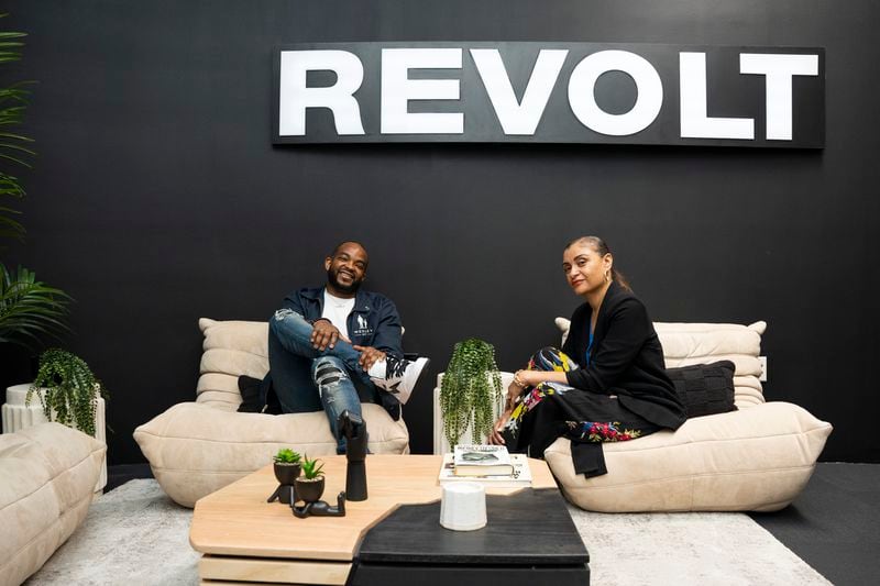 CEO of Revolt Media & TV, Detavio Samuels, (left) chats with Revolt Atlanta President, Monique Chenault (right), in the Atlanta studio on Monday, May 8, 2023.   (Olivia Bowdoin for the Atlanta Journal Constitution). 