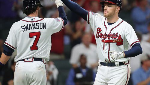 Freddie Freeman is greeted following what is sure to be among the first of many home runs he hits at the Braves new home park. (Curtis Compton/ccompton@ajc.com)