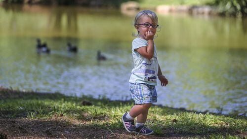 A child plays near a North Georgia lake in June 2017. JOHN SPINK/JSPINK@AJC.COM.