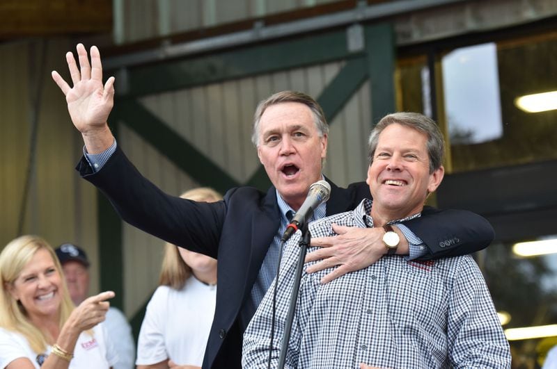 Former U.S. Sen. David Perdue, left, is considering a run against Gov. Brian Kemp in next year's GOP primary. Such a race would drive each of the candidates further to the right, potentially leaving the winner weakened in a likely battle against Democrat Stacey Abrams. HYOSUB SHIN / HSHIN@AJC.COM