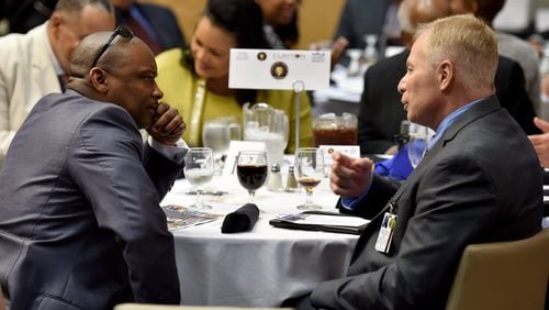 Clayton County Police Chief Michael Register, right, and Clayton County Sheriff Victor Hill talk at Clayton County’s Annual State of the County Address last March. BRANT SANDERLIN/BSANDERLIN@AJC.COM