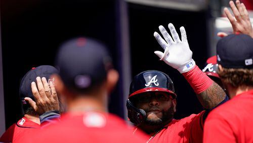 Braves pinch hitter Pablo Sandoval (center right) celebrates after hitting a home run in the sixth inning Thursday, April 15, 2021, against the Miami Marlins at Truist Park in Atlanta. (Brynn Anderson/AP)