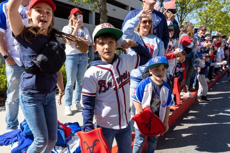 Fans cheer for players during a parade before the Braves home opening day game versus the Diamondbacks at Truist Park in Atlanta on Friday, April 5, 2024. (Arvin Temkar / arvin.temkar@ajc.com)