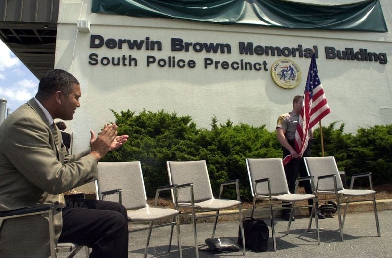 010412 Dekalb County Ga: Thomas Brown Sheriff of Dekalb County applauds to the unvieling of Derwin Brown's name , slain sheriff elect, on the Dekalb County South Precinct building in honor of Derwin Brown . April 12, 2001 (Renee' Hannans/Staff).