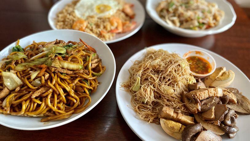 Among the tantalizing dishes at Two Fish Myanmar are stir-fried noodles with beef (left) and grilled pork with noodles; in the background are shrimp fried rice (left) and meeshay (noodles with chicken and gravy). Wendell Brock for The Atlanta Journal-Constitution