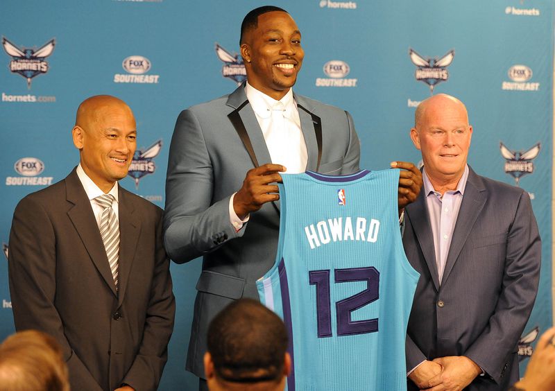 The Charlotte Hornets new center Dwight Howard poses with his jersey alongside General Manager Rich Cho (left) and head coach Steve Clifford during a news conference Monday.