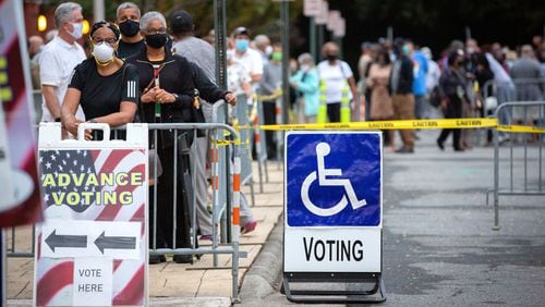 Long lines form outside the Cobb County Board of Elections and Registration offices for the first day of early voting Monday. STEVE SCHAEFER / SPECIAL TO THE AJC
