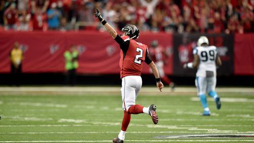 Falcons quarterback Matt Ryan celebrates after connecting with wide receiver Julio Jones for a 75-yard touchdown against the Carolina Panthers in the Georgia Dome Sunday. The Falcons won behind Ryan’s 503 passing yards and Jones’ 300 receiving yards, both franchise records. (Brant Sanderlin / bsanderlin@ajc.com)