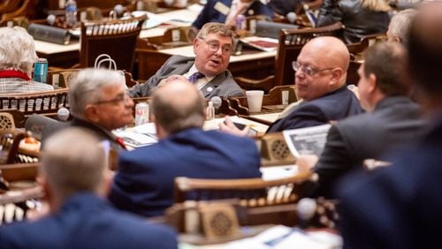 State Rep. Gerald Greene (center), R-Cuthbert, speaks with colleagues in the House of Representatives in the Capitol in Atlanta on Tuesday, January 9, 2024. (Arvin Temkar/arvin.temkar@ajc.com)