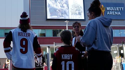 Arizona Coyotes fans start to gather for what is expected to be the franchise's final NHL hockey game in the Phoenix area, against the Edmonton Oilers, at the main entrance to Mullett Arena on Wednesday, April 17, 2024, in Tempe, Ariz. (AP Photo/Ross D. Franklin)