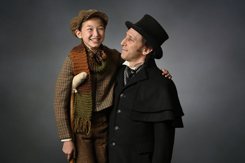 Chloe Gia Bremer (left) as Tiny Tim and Andrew Benator as Ebeneezer Scrooge are part of a new adaptation of "A Christmas Carol" at the Alliance Theatre. Photo: courtesy the Alliance Theatre