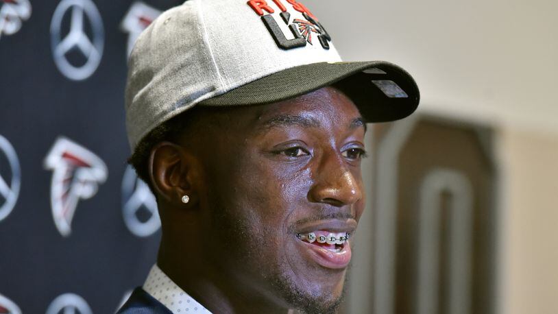 Falcons first-round pick Calvin Ridley is all smiles and orthodontics during his introductory press conference at the Falcons training facility Friday. (HYOSUB SHIN / HSHIN@AJC.COM)