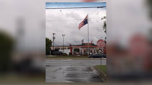 The American flag was flown upside-down briefly in front of a fast-food restaurant in North Georgia. (Credit: Facebook)