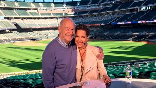 In this March 2017 photo provided by Hannah Storm, Mike Storen poses with daughter Hannah Storm at the Atlanta Braves' new ballpark in Atlanta. Storen, a former ABA commissioner and multisport marketing whiz, died Thursday, May 7, 2020. He was 84. Storm said her father died at Emory University Hospital in Atlanta of complications from cancer. (Courtesy of Hannah Storm via AP)