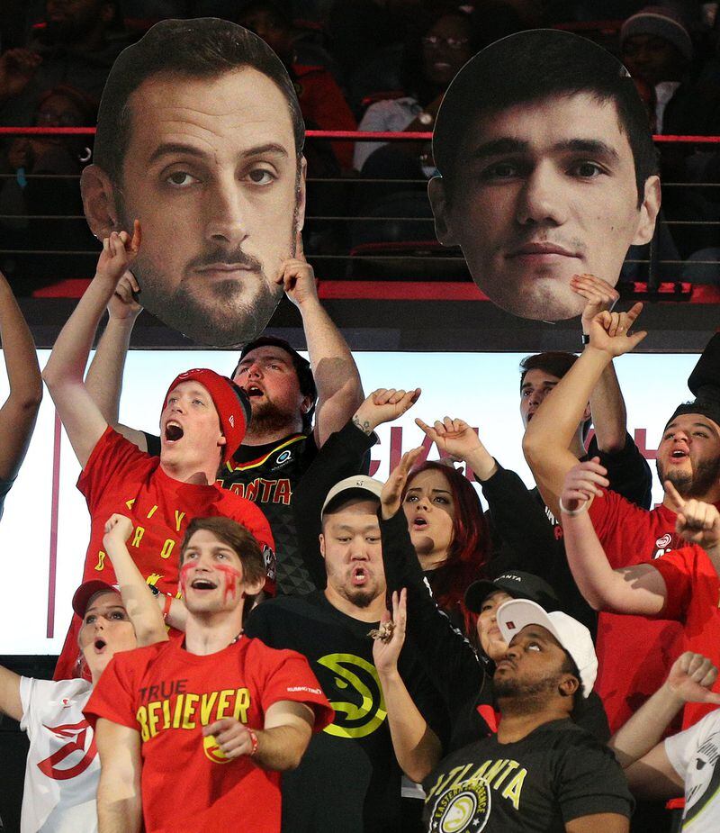 Members of the 6th Man Section cheer for Hawks players Marco Belinelli and Ersan Ilyasova against the Raptors in a recent NBA game. CURTIS COMPTON / CCOMPTON@AJC.COM