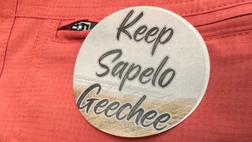 A sticker saying "Keep Sapelo Geechee" is worn on the shirt of George Grovner, a resident of the Hog Hummock community on Sapelo Island, during a meeting earlier this month of the of McIntosh County Commission in Darien. Commissioners voted to double the maximum size of homes allowed in the tiny community of people known as Gullah Geechee, who are descended from enslaved people who worked coastal plantations. Residents say they fear the zoning change will raise their property values and taxes, potentially forcing them to sell their land. (AP Photo/Ross Bynum)