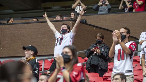 Falcons fans celebrate a touchdown against the Denver Broncos at Mercedes-Benz Stadium on November 8, 2020. (Photo by Alyssa Pointer/AJC)