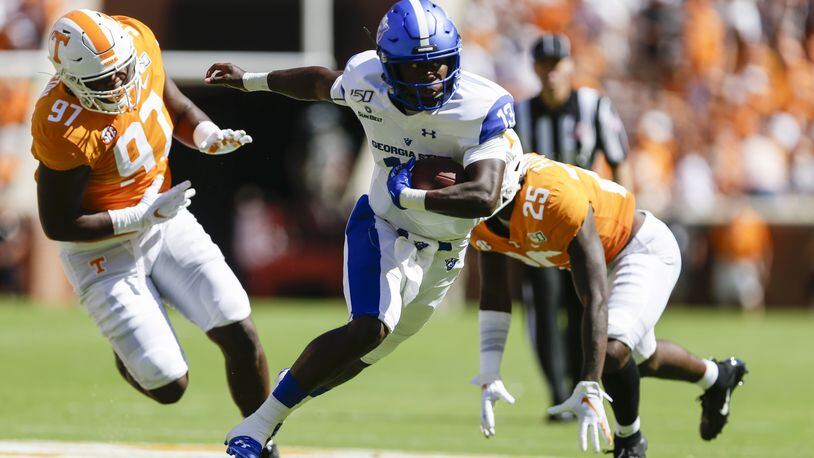 Georgia State quarterback Dan Ellingston parts a pair of Tennessee defenders for another good gain Saturday. (Photo by Silas Walker/Getty Images)