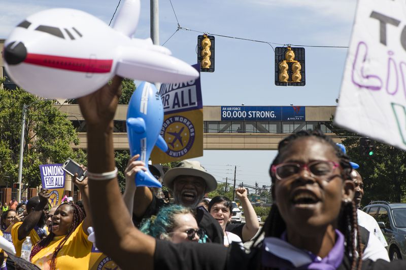 Protesters demonstrate in front of Delta Headquarters during the Airport Workers United march to Delta Headquarters on Saturday, June 3, 2023, in Atlanta. Over 200 protesters marched to demand higher wages. CHRISTINA MATACOTTA FOR THE ATLANTA JOURNAL-CONSTITUTION 