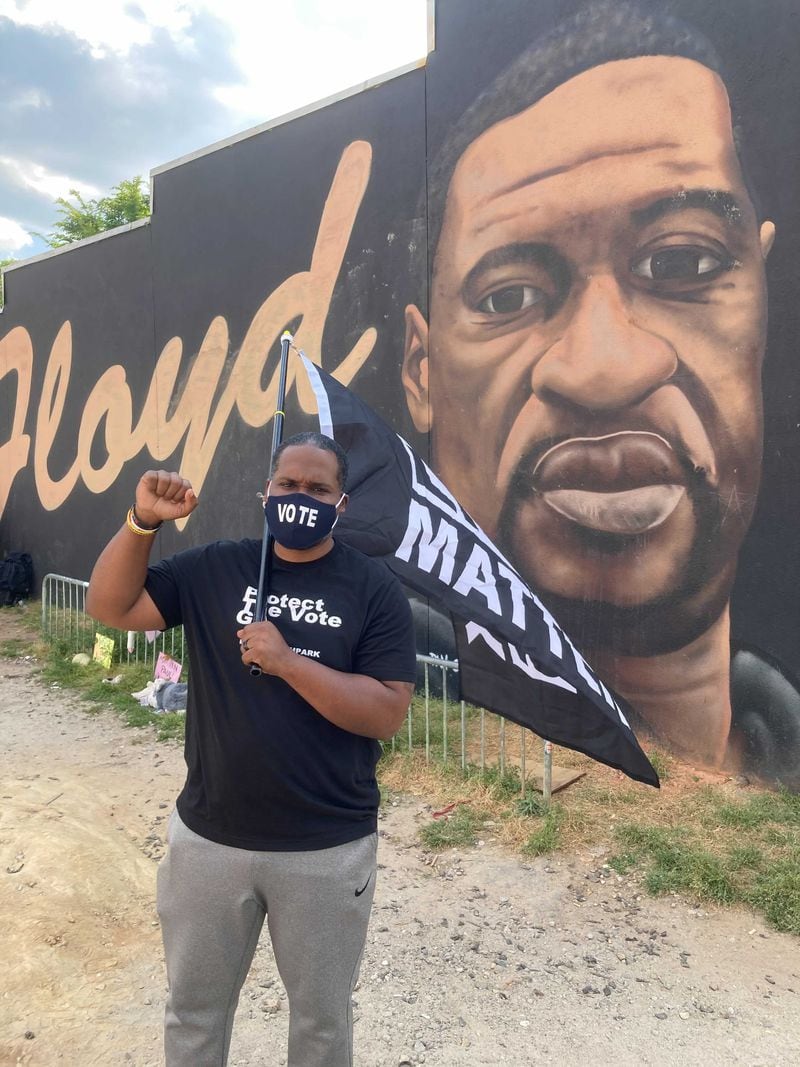Civil rights attorney Gerald Griggs stood with a Black Lives Matter flag at the George Floyd mural on Edgewood Avenue in Atlanta after the verdict came in.