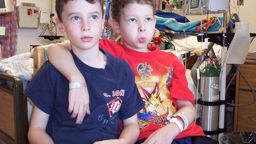 Killian Owen right with his twin brother Garrett playing video games while Killian was being treated with an experimental therapy at the National Institutes of Health in Bethesda, Maryland. The photo was taken in 2003, two months before Killian died. (Photo contributed by Owen family)
