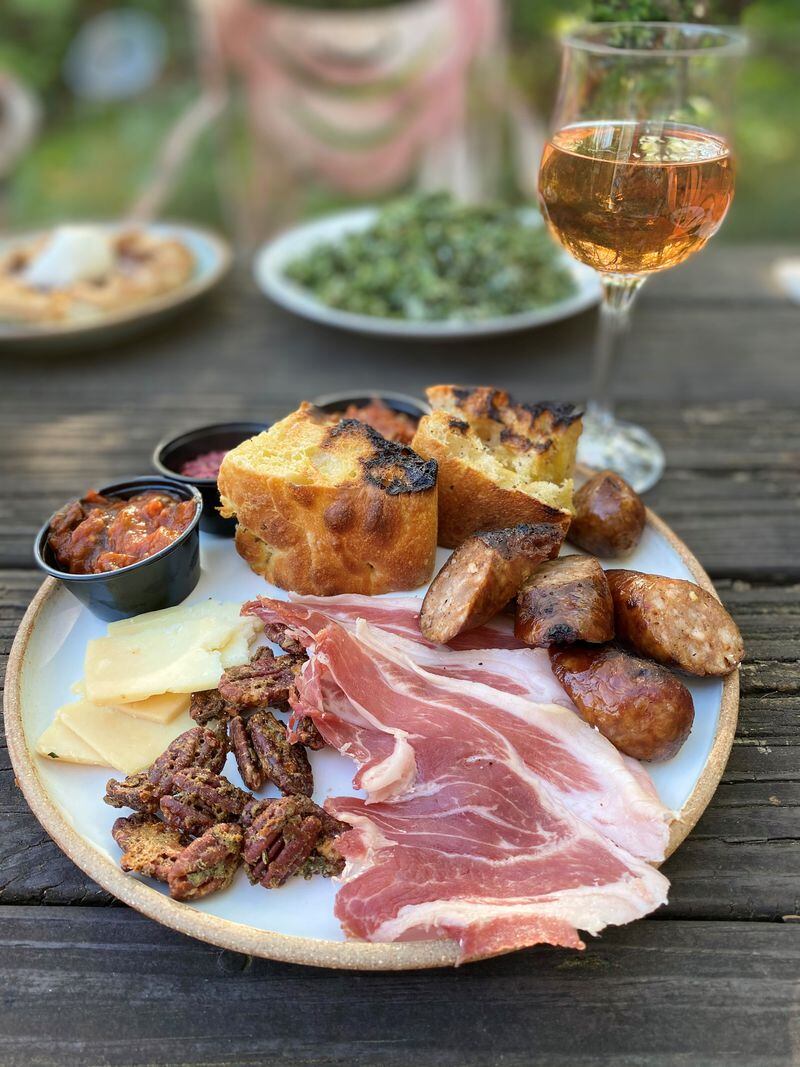 Baffi’s antipasti plate includes smoked Italian sausage, prosciutto, cheese, candied pecans, caponata, toasted focaccia and more. Wendell Brock for The Atlanta Journal-Constitution