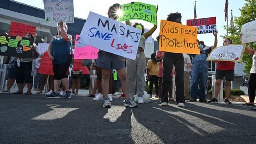 Parents hold a rally at the Cobb County School District's headquarters to encourage leaders to require masks for students and staff on August 12, 2021.  (Hyosub Shin / Hyosub.Shin@ajc.com)