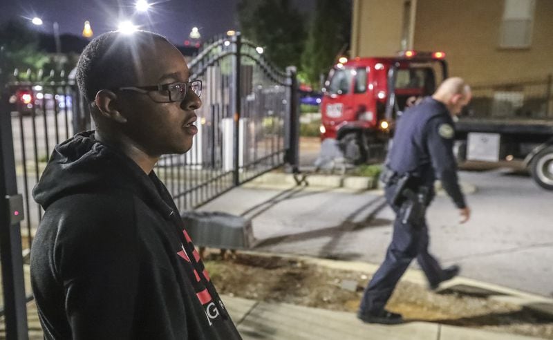 Morehouse student, Deaven Rector, 19, waits for a tow truck to remove his car after he was carjacked. The Morehouse College student was not injured in the carjacking that took place early Tuesday morning after he left a campus library in southwest Atlanta. His car was later located by police.
